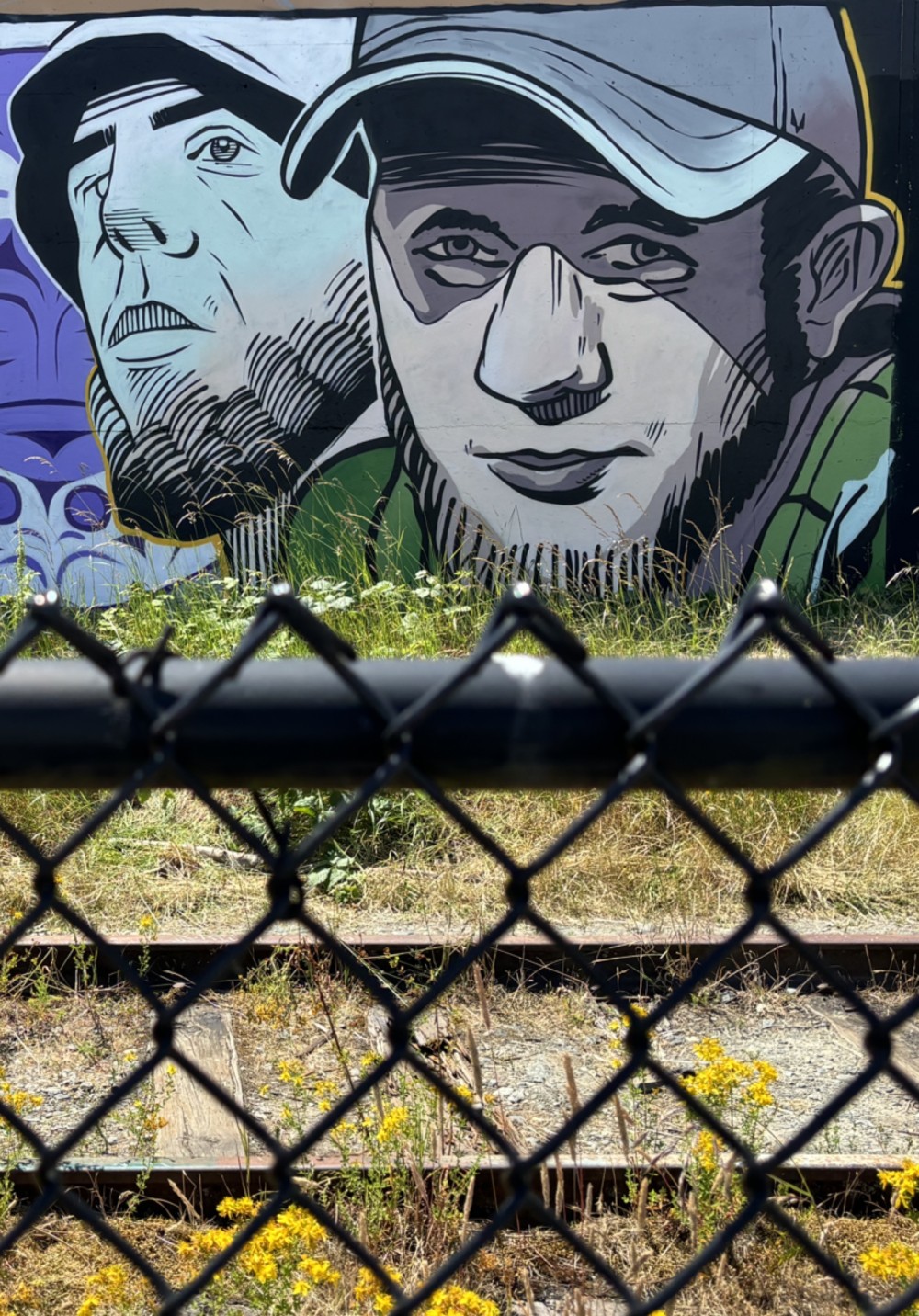 The work explores the theme of boundaries — physical, social, and psychological. Two adjacent portraits are perceived through a fence, which becomes a metaphor for systems of control, separation, and unequal access to freedom and visibility.

Stripped of specific identity, the figures invite the viewer to read them as a collective experience: migration, labor, war, and the condition of existing “on the other side” of societal structures. The work raises questions about who defines these boundaries and whom they are truly meant to protect.