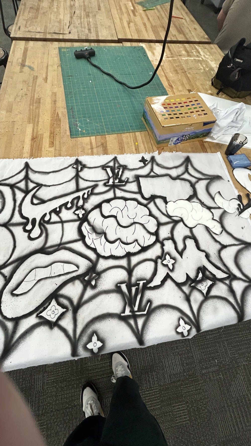 ‘Nike Swoosh’ , ‘Kappa’ , ‘Creative Brain Power’ , ‘Louis Vuitton’ , ‘Straight teeth clenching lip’ Credited designs caught in spider web’