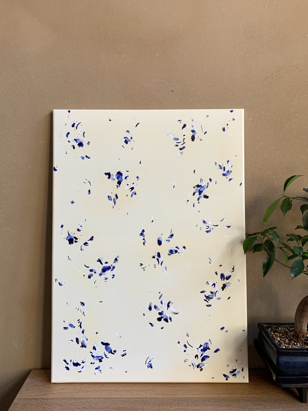 "Spring" is a transitional work. It is the first piece she created on canvas after several years of working on paper—a symbolic shift in her artistic journey. The title, Spring, evokes both the season of renewal and an inner momentum toward openness.

This work is composed of delicate ink stains, inspired by camellia petals carried by the wind. It speaks of the passage of time, of what it takes away, but also of what it leaves behind: a subtle, fragile beauty—almost invisible unless one takes the time to truly look.

Upon closer inspection, viewers will discover birds, fish, mountains... elements that belong to her inner, sensitive world.