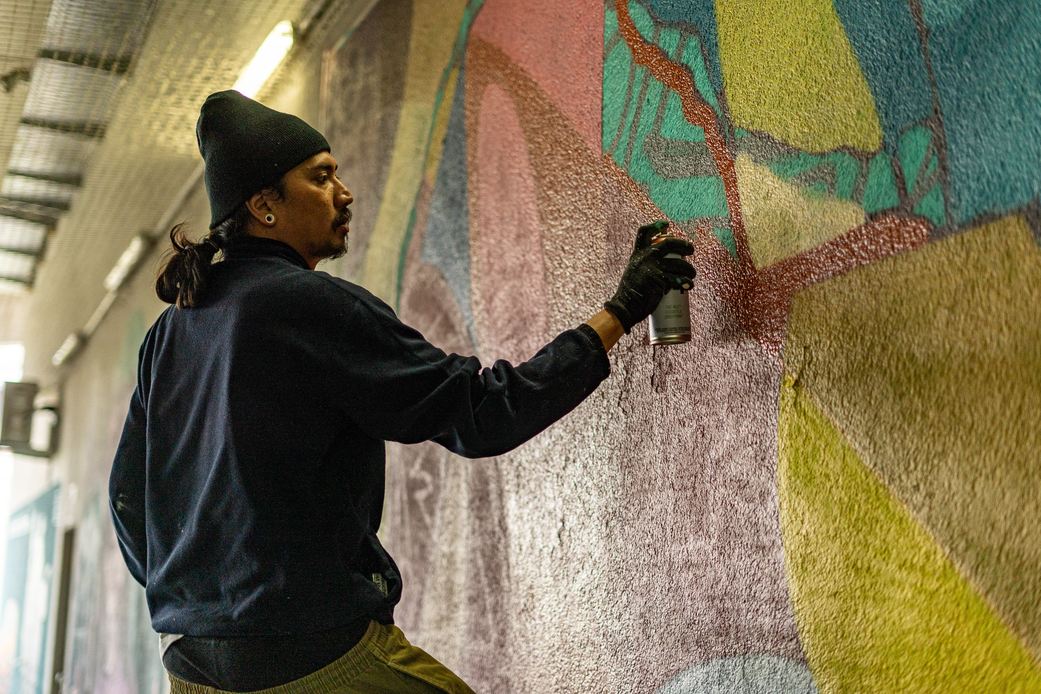 Daniel Parasaudi as known as Emeteur is a multimedia artist whose journey began in 2005 as a graffiti artist and has since evolved into a professional muralist. Known for his striking use of shape and color, Daniel’s work draws deeply from Indonesian cultural influences, infusing his murals with patterns, symbols, and a vibrant palette that celebrates his heritage.

Born in Sukabumi, Indonesia, in 1988, Daniel’s artistic journey has taken him from Lombok to Berlin, Germany, where he now resides and works as a full-time artist. His murals can be found in public spaces and galleries, transforming environments into reflections of both traditional and contemporary Indonesian aesthetics. Daniel’s work invites viewers to experience a dynamic fusion of cultural identity and modern expression, making him a distinctive voice in the international art scene.