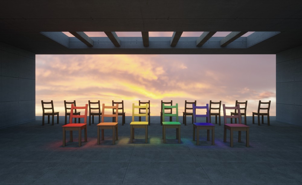 A collection that highlights the symbolism of human connection through the use of minimalism, geometry, and the management of empty space to convey a deep emotional message. By using the simplicity of elements, it transmits a profound sense of isolation and reflection.
In this piece, titled "Diversity," I aimed to capture the richness of human variety and the importance of inclusion. I used the symbolism of the rainbow in the chairs to represent the different identities, cultures, and perspectives that make up our society. The colored chairs, placed at the center of the composition, stand out against the neutral chairs on the edges, creating an intentional contrast that highlights the beauty of diversity versus homogeneity.
The open setting, with a warm sky at dawn, reinforces the feeling of hope and renewal, a space where everyone has a place. The soft light bathing the colored chairs is crucial in creating an atmosphere of acceptance and mutual respect, where each difference is value