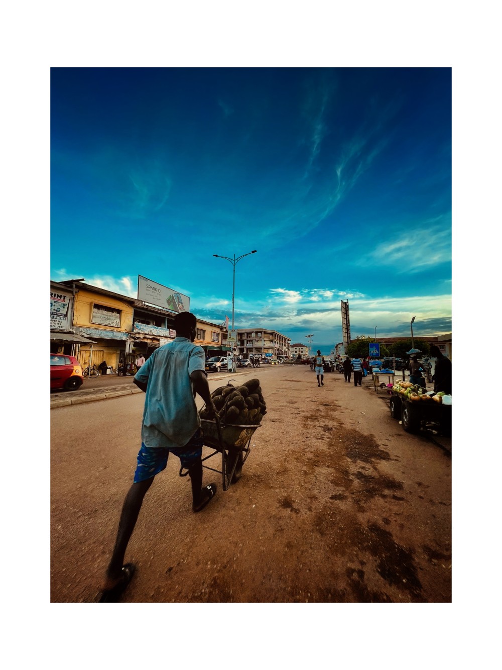The street he walked on was alive with its own kind of music. Vendors were arranging their goods, shouting prices in voices hoarse from years of bargaining. A mother pulled her child along, clutching a shopping bag in one hand and a scolding finger in the other. A boy on a rusty bicycle weaved dangerously through the chaos, delivering loaves of bread stacked high on his head. Each sound, each movement, contributed to a tapestry of industry and survival.

Yet, amidst the din, he stood out. Not because he demanded attention, but because he didn’t. His focus was unwavering, his pace deliberate. There was a quiet determination in the way he moved, a refusal to be swallowed by the cacophony around him.

To the casual observer, he might have seemed like just another hustler a cog in the great, grinding machine of urban life. But those who knew him truly saw him understood that his story was different. Created By Kwaku Kr3