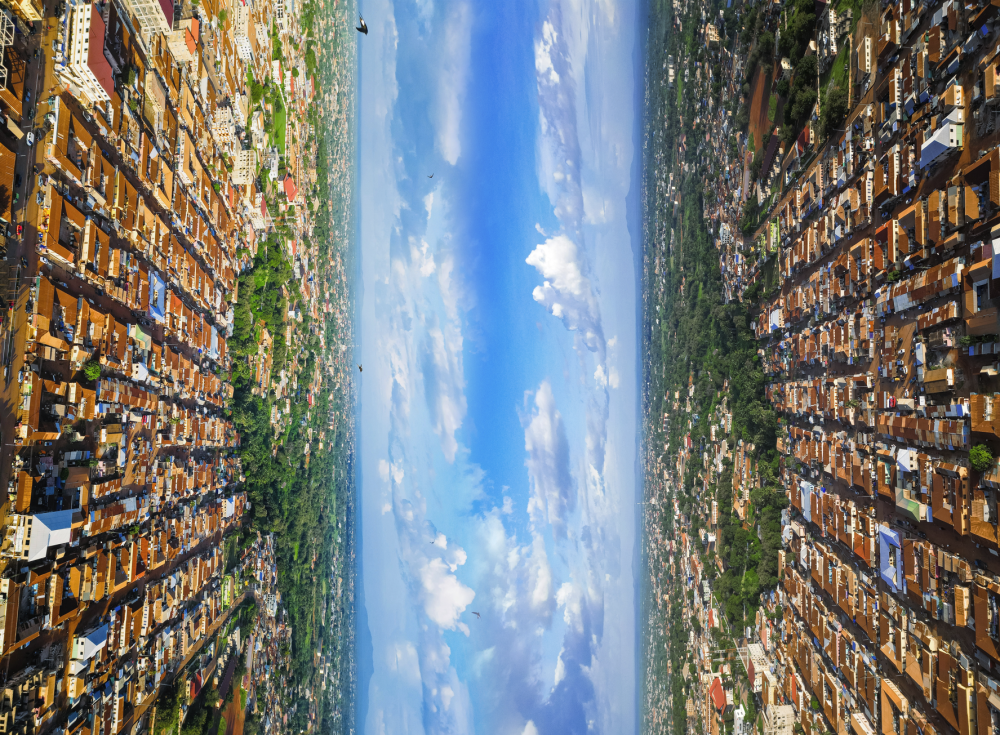 The Heartbeat of Home" is a visual masterpiece that challenges perception and celebrates the profound bond between identity, culture, and environment. At first glance, the artwork's mirrored perspective creates a puzzling illusion, drawing viewers into a world where up and down converge, blurring the lines between reality and abstraction.
This piece captures a vibrant urban landscape paired with a lush natural expanse, symbolizing the harmony between tradition and modernity. The central axis of the sky serves as a heartbeat, a pulsating reminder of life connecting the bustling city and the enduring serenity of nature.
Asamoah William, also known as Kwaku Kr3, uses this artwork to explore the intricate connection to "home," both as a physical place and as an emotional anchor. The intentional disorientation provokes the viewer to reconsider their relationship with the spaces they inhabit and their origins.

Created By Kwaku Kr3