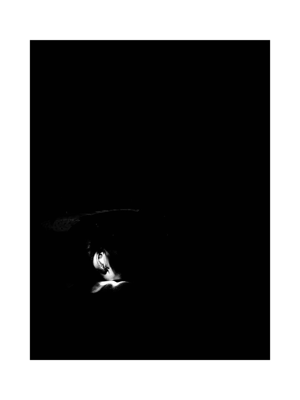 This artwork delves deeply into the notion of self-awareness and the vulnerabilities that come with introspection. The central image a solitary eye illuminated against a stark black background represents the unguarded human soul. It is a metaphorical gateway, inviting viewers to reflect on their own inner landscapes, fears, and untold truths. The darkness surrounding the eye is not just a void; it signifies the unexplored depths of human emotions and memories, some buried out of fear and others forgotten with time. The contrasting light on the eye draws attention to how we selectively allow the world to glimpse fragments of our inner selves, hiding what feels too fragile or too raw to expose. The choice of monochrome is deliberate, stripping away the distractions of color to emphasize form, light, and shadow. This minimalism mirrors the process of self-discovery layer by layer, shedding embellishments to uncover an authentic core. The artwork poses a silent question to its audience.