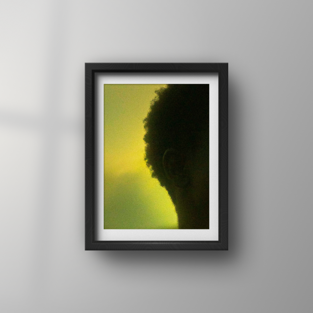 Against the background of the beautiful red-orange sunset, set into the crystal-clear blue sky atop a hill, we captured this moment. Using a projector, the symbol of Legba was cast onto the face of the model. Legba, or Papa Legba, is a lwa/Spirit in Haitian Vodou culture. Legba is often depicted as an old man; however, this photograph does not depict Legba. It depicts one who calls on Papa Legba to "open the doors!" for them.