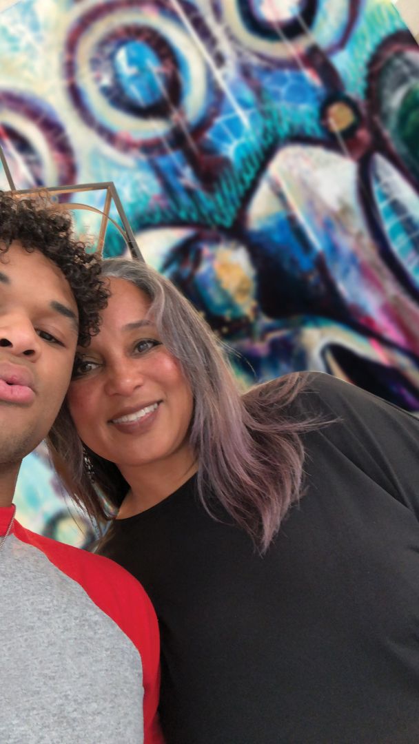 As an artist, I create from a place of truth, vulnerability, and transformation. My work explores identity, self-acceptance, and the complex emotional landscapes we navigate as human beings—especially as women. At the heart of my practice is a desire to encourage others to love themselves, love each other, and love life—without judgment. I believe that our flaws are not failures but features of our humanity, and I aim to celebrate that through every brushstroke and textured layer on my canvas.
Much of my inspiration stems from my personal journey. Growing up in a conservative and strict environment, I often struggled with body image and the pressure to conform. That struggle eventually turned into rebellion—and my rebellion took the form of painting nude women. At first, it was deeply personal and therapeutic. Painting nudes helped me confront and eventually embrace my own body. It became a visual affirmation: if I could stand naked before a mirror and love the person I saw, then I had won the battle for self-worth.
Now, my focus has evolved into empowerment. I paint the female body as a declaration of acceptance. Too often, we’re taught to hide our imperfections, to improve or erase parts of ourselves to be “enough.” But through my art, I want to say: You already are. I want women to see themselves in my work and feel bold, seen, and celebrated—flaws and all.
Stylistically, I describe my work as abstract and symbolic. My paintings often have a celestial or ethereal quality to them—representing not the physical self, but our inner world. Each piece becomes a layered conversation about self, vulnerability, and healing.
While acrylic paint is my foundational medium, my creative process is driven by instinct and experimentation. I use whatever materials speak to me in the moment—plaster, gold leaf, wire, nails, sand, real flowers, ink, glass beads, or textured gels. I see these materials not just as tools, but as metaphors. A nail beside an orchid might symbolize the hard and the soft within us all. I often use curved and straight lines to represent opposing perspectives coexisting in harmony. These contrasts are not accidents—they are intentional expressions of balance.
My philosophy is simple: life is layered, complicated, beautiful, and messy—and so is my art. What I experience emotionally and spiritually always finds its way onto the canvas. I believe that most of us aren’t fully honest about who we are or what we feel. My goal is to tell that truth—boldly and without apology. I’m not trying to depict perfection. I’m trying to honor reality. To show that hope and desperation, light and dark, can live in the same painting—and in the same person.

As an artist, I hope to provoke thought, inspire healing, and make space for emotional honesty. If someone sees themselves in my work and feels more whole because of it, then I’ve done what I came here to do.