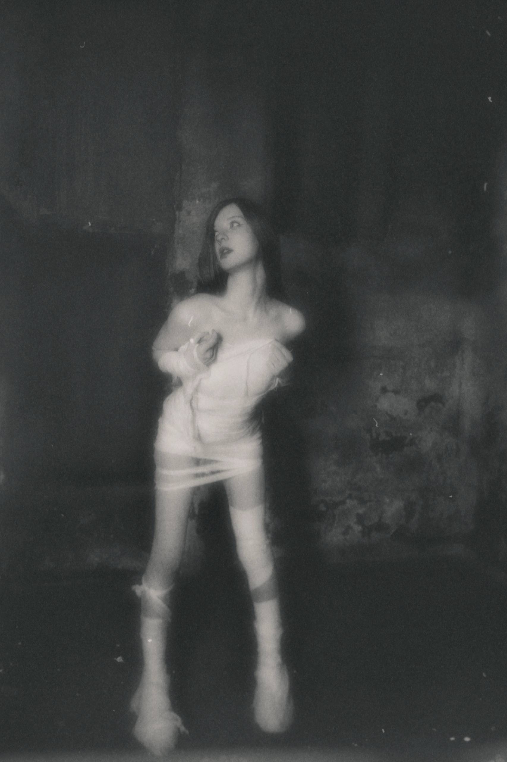 Nika Lynas (Veronika Pankova) is a digital artist and author from Russia whose visual narratives intertwine introspection and dark fantasy. In her work, she explores the inner states of the human psyche — psychological trauma and disorders, vulnerability, and isolation — through imagery that merges meta-symbolism, psychological realism, and digital distortion. Her practice includes digital painting, photo, and video performance.

In 2024, she created the project "The Face of Introspection" — a series of confessional works and performances addressing female subjectivity, emotional abuse, and healing.

Beyond visual art, she is the author of CRYolite, a book that combines autobiography, psychological thriller, and literary fiction. It examines self-isolation as a form of creative freedom and portrays the creative journey and the harsh, often solitary reality of artists who struggle for years to find their place in the industry.

Her works have been exhibited in Mumbai, New York, Montreal, Larnaca, Limassol, and Moscow, and featured in a Romanian anthology of contemporary digital art and the international magazine Visual Art Journal. She lives and works between inner space and digital worlds.

She presents a selection of works from her large-scale series, The Face of Introspection. It is a reconstruction of memory and an exploration of psychological trauma that does not fade with time. Instead of direct storytelling, she gives unspoken emotions—fear, anger, passion—an ephemeral and enigmatic form, preventing the viewer from drawing quick conclusions. Her goal is not only to depict pain but to make it tangible, revealing its fragile beauty.

It is an act of humanizing inner chaos: transforming personal vulnerability into myth, and darkness into structure. Each work becomes an observation of how a vague feeling crystallizes into an image. To achieve this, the artist employs digital distortions, cold light, textures, and detail to emphasize the distance between genuine experience and its visual manifestation. At times, she transcends the digital walls and concludes her philosophical statements with physical performances, creating eternal and complex artifacts that then live on with those who were her muses.

Her practice is about creating evidence of human fragility exploring the boundary between pain and beauty, and reminding us of the necessity to look into the darkness in order to see the light.