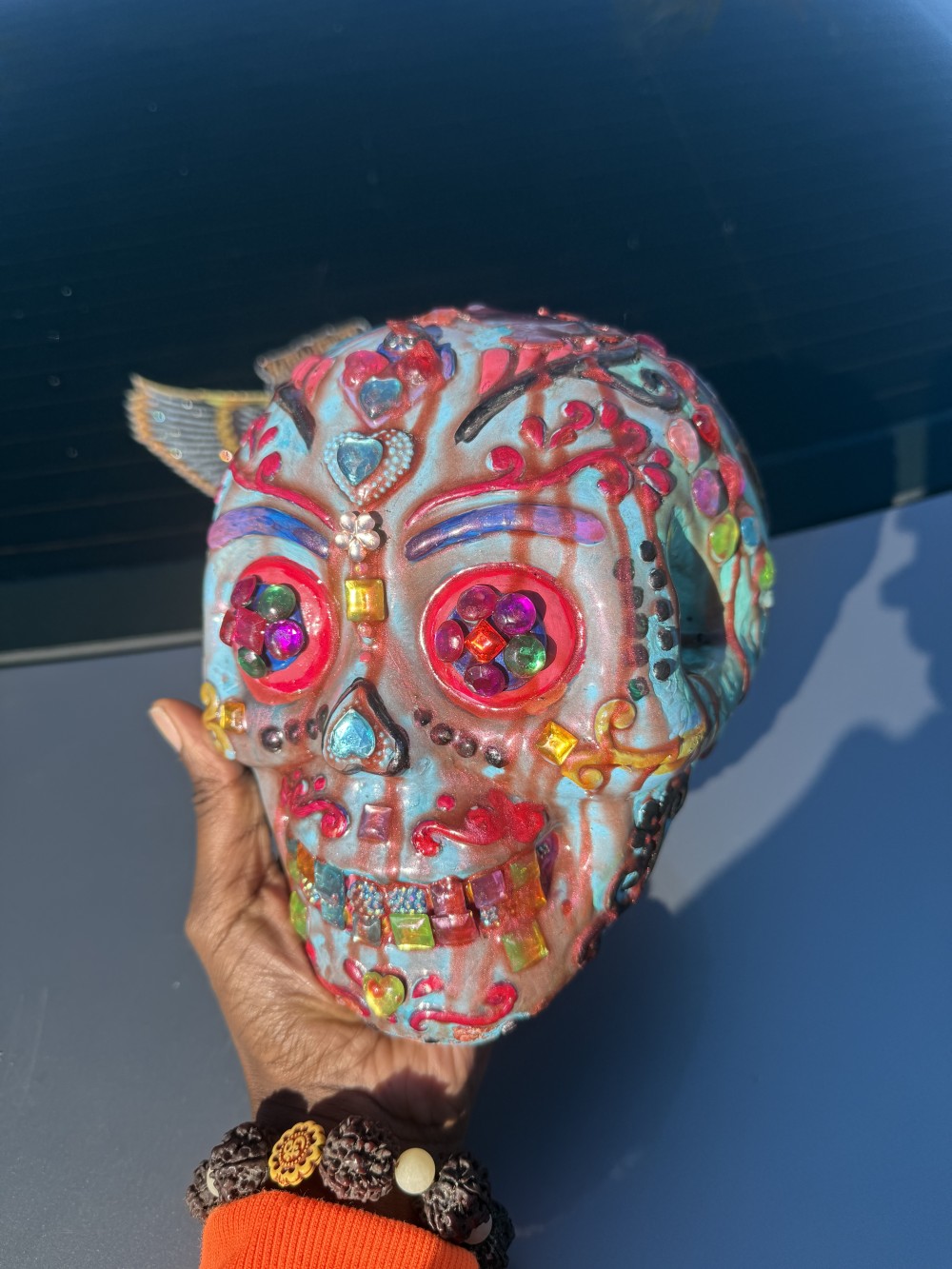 Resin skull painted with acrylic covered in resin and adorned in jewels